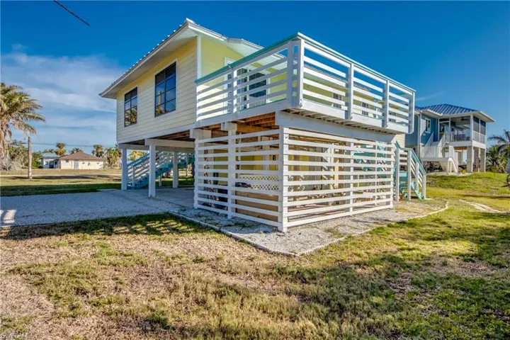 Rear view of house featuring a lawn