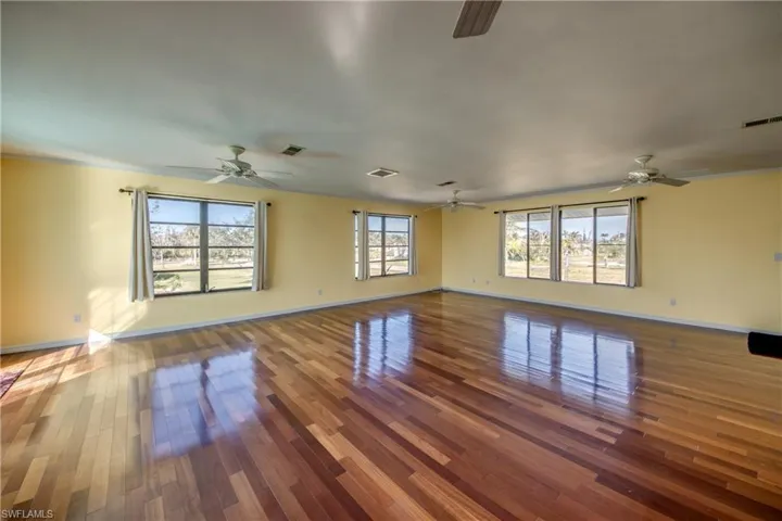 Empty room with wood-type flooring and plenty of natural light