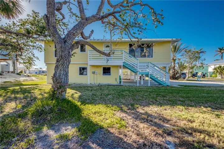 Rear view of house with a yard