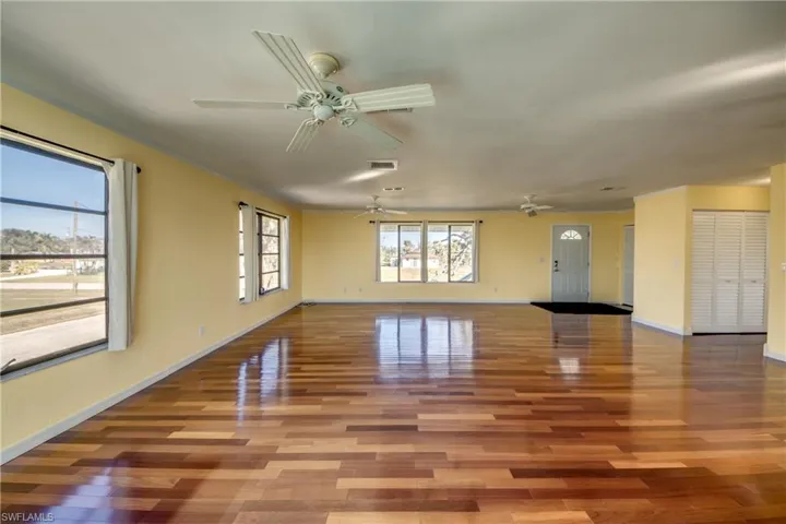 Unfurnished room with hardwood / wood-style floors and ceiling fan