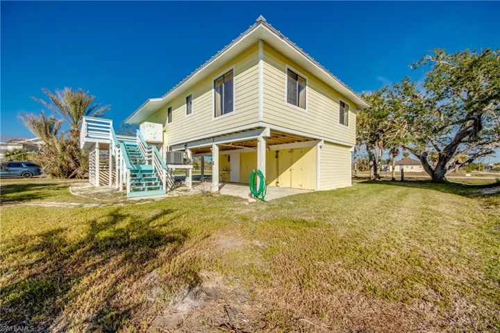 Rear view of property featuring a yard and a patio area