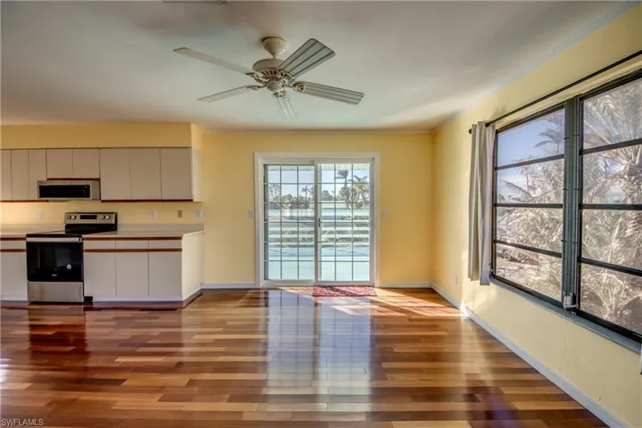 Kitchen with white cabinetry, crown molding, stainless steel range with electric cooktop, and light hardwood / wood-style flooring