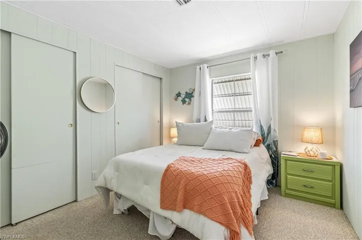 Bedroom featuring two closets and carpet flooring
