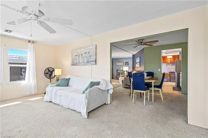 Bedroom featuring carpet floors and freestanding refrigerator