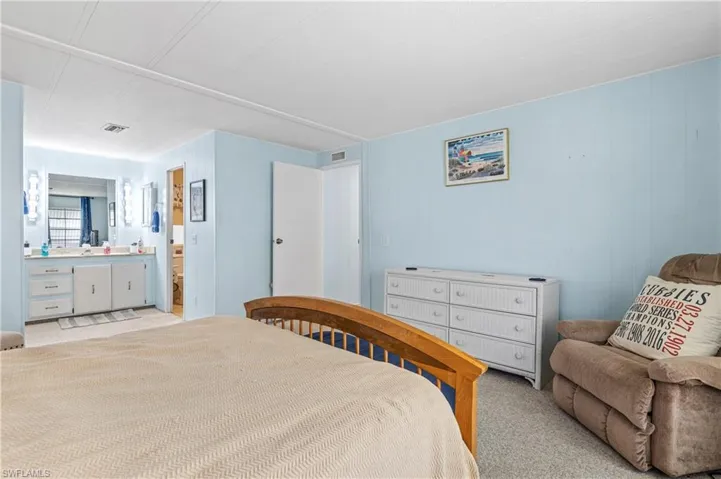 Bedroom with light colored carpet