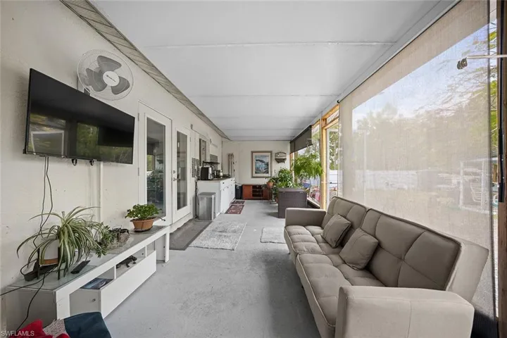 Sunroom / solarium with concrete flooring and french doors