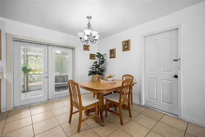 Dining room with a chandelier and light tile patterned floors