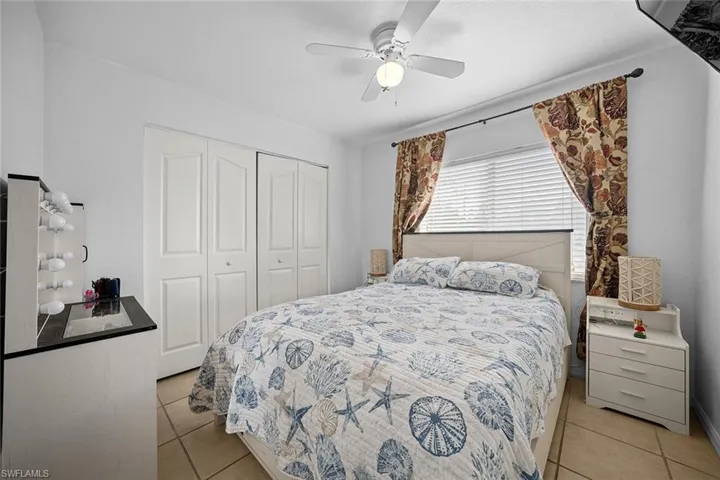 Bedroom featuring ceiling fan, a closet, and light tile patterned floors