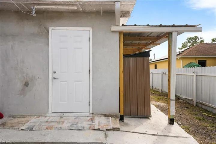 Doorway to property with stucco siding and a patio