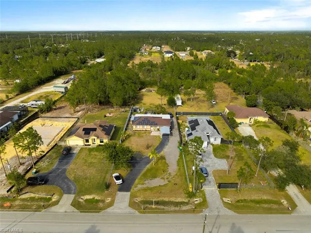 Aerial perspective of suburban area featuring a forest