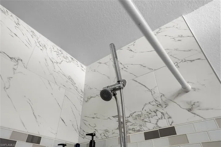 Bathroom view of a marble finish shower