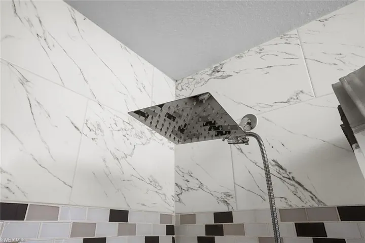 Bathroom view of a marble finish shower