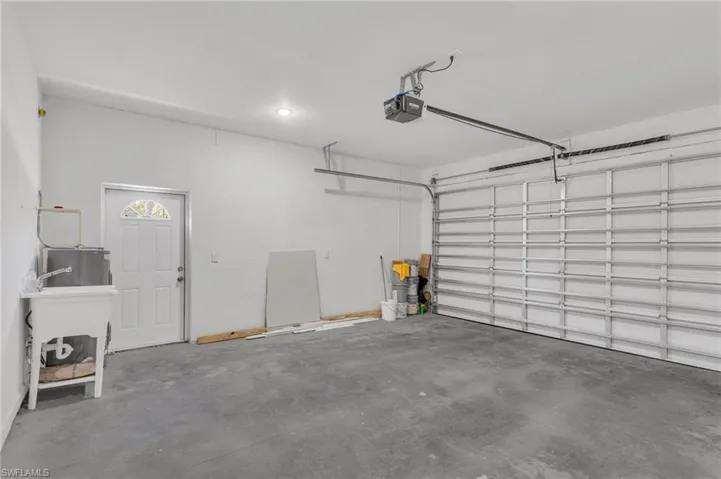 Garage featuring a sink and a garage door opener