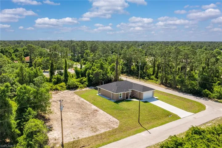 Aerial view featuring a wooded view