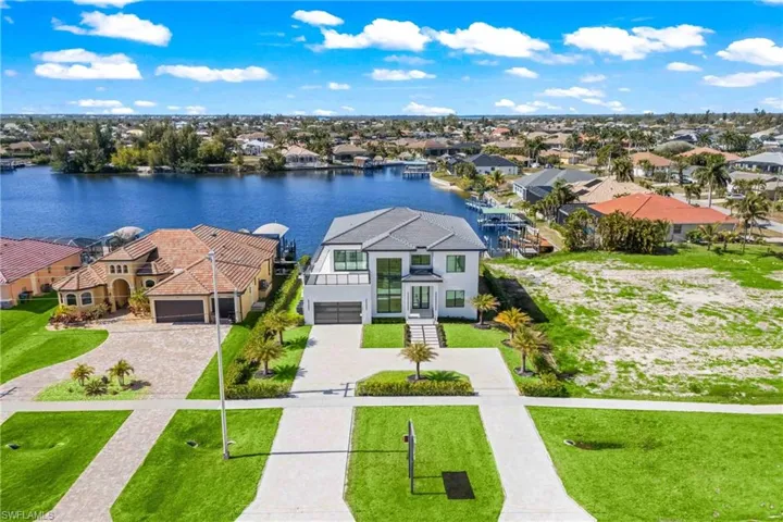 Aerial perspective of suburban area with a nearby body of water