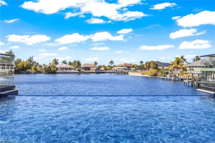 Water view with nearby suburban area and a dock