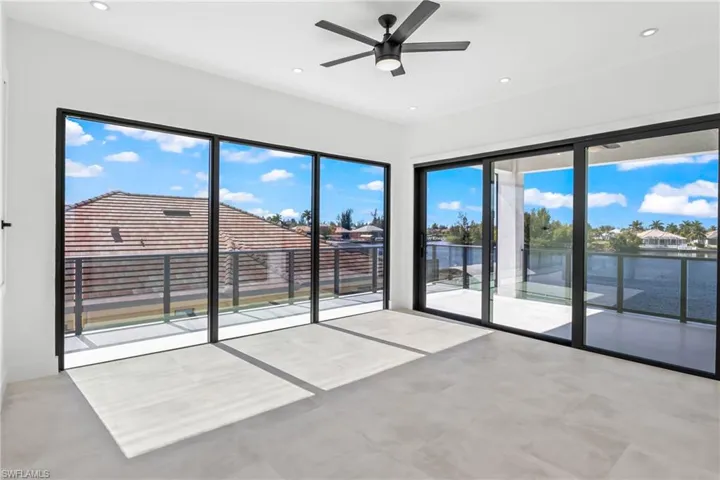 Spare room with ceiling fan, a water view, recessed lighting, and concrete floors