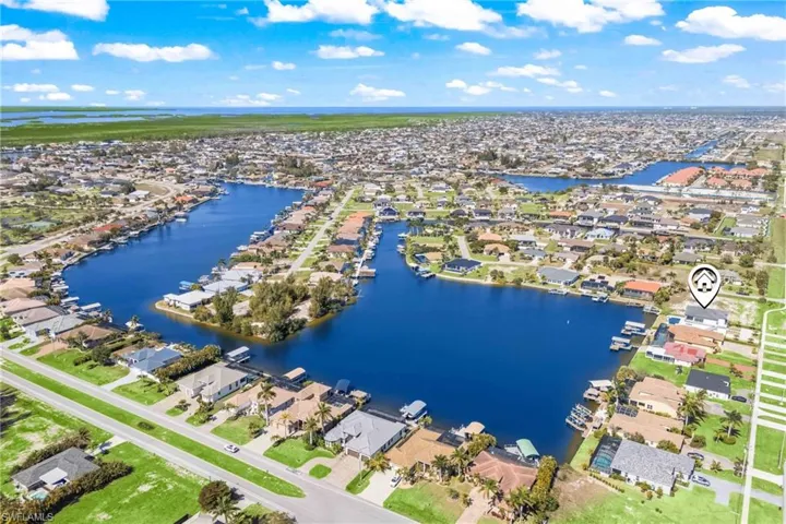 Aerial overview of property's location with nearby suburban area and a large body of water