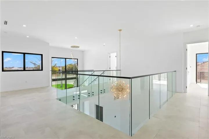 Hallway featuring recessed lighting and an upstairs landing