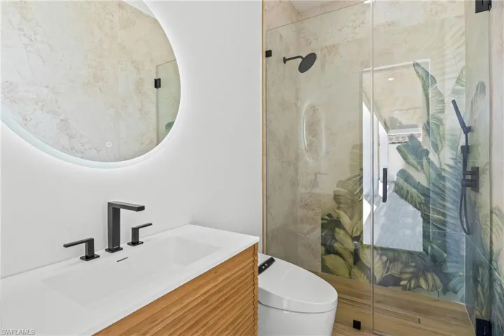 Full bathroom featuring a stall shower and vanity