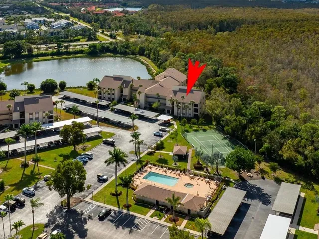Aerial view of a pool and a nearby body of water