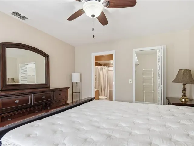 Bedroom with ensuite bath and ceiling fan