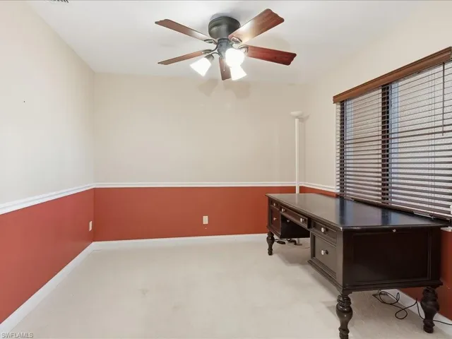 Unfurnished office featuring carpet and a ceiling fan