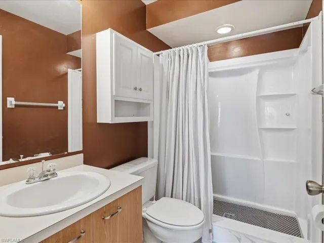 Bathroom with a shower stall and vanity