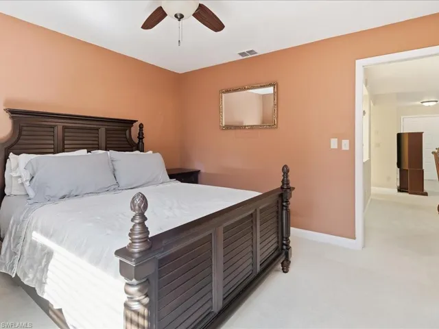 Bedroom featuring ceiling fan and light carpet