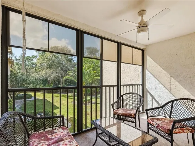 Sunroom / solarium featuring ceiling fan and a balcony