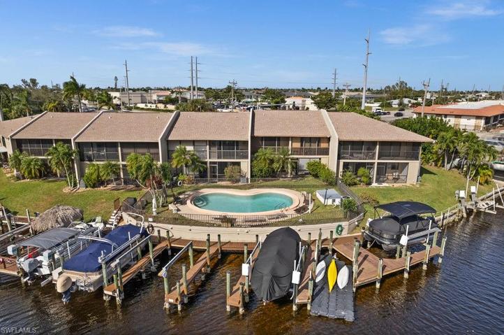 Back of Condo with pool and dock.
