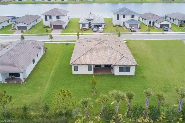 Aerial perspective of suburban area with a large body of water