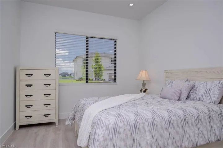 Bedroom featuring baseboards and light wood-type flooring