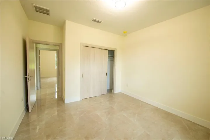 Unfurnished bedroom with baseboards and a closet