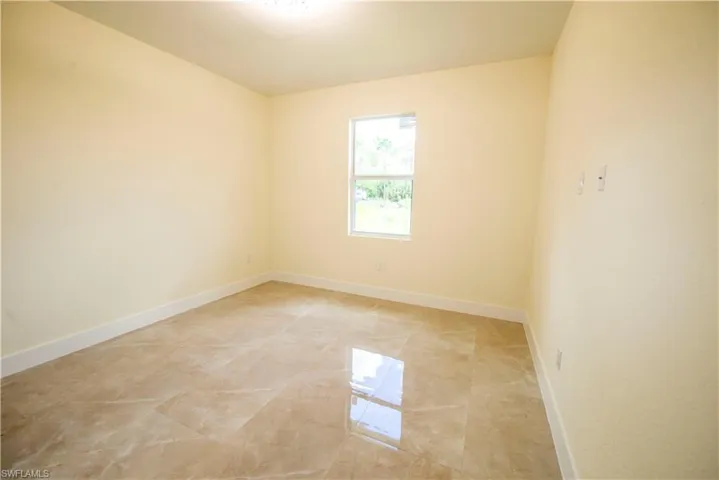 Unfurnished room with baseboards