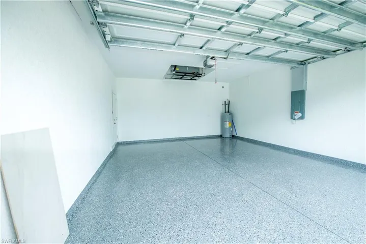 Garage with electric water heater and electric panel