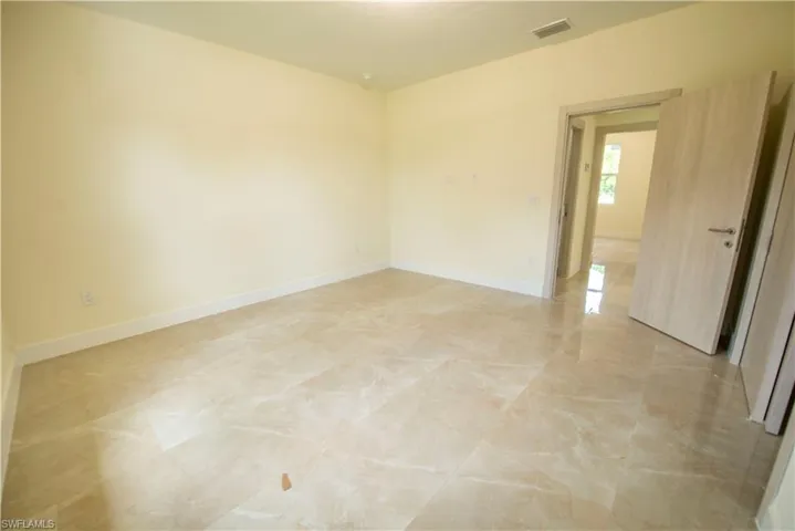 Spare room featuring baseboards