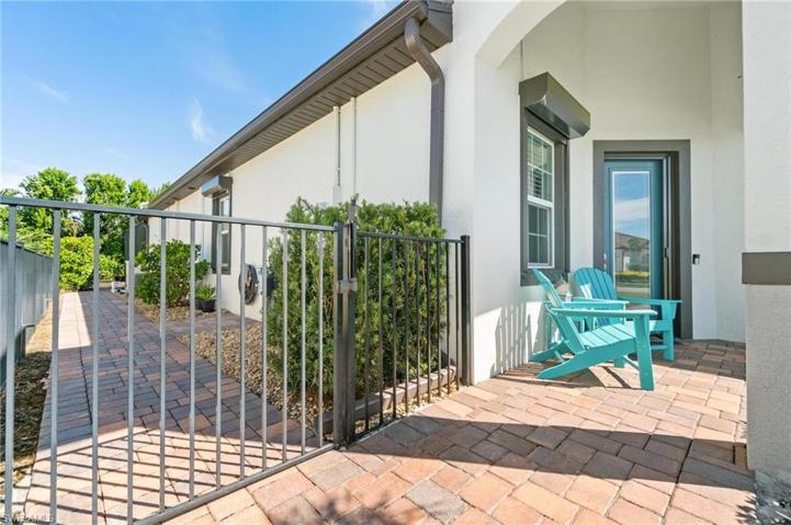 Brick paver walkway on the left side of the home leads all the way to the backyard along the lanai screen.
