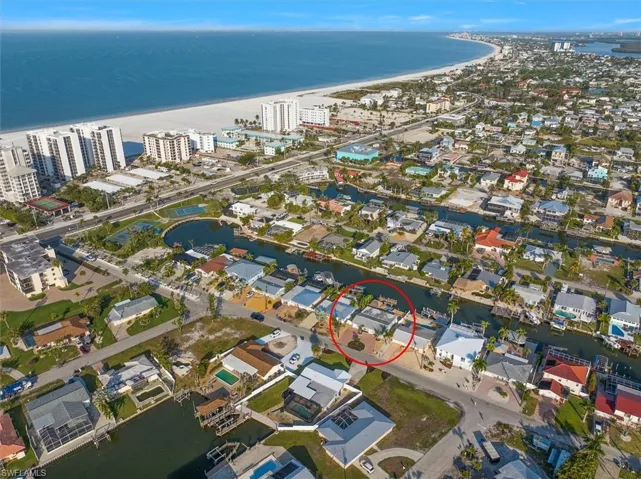 Aerial view featuring a beach view and a water view