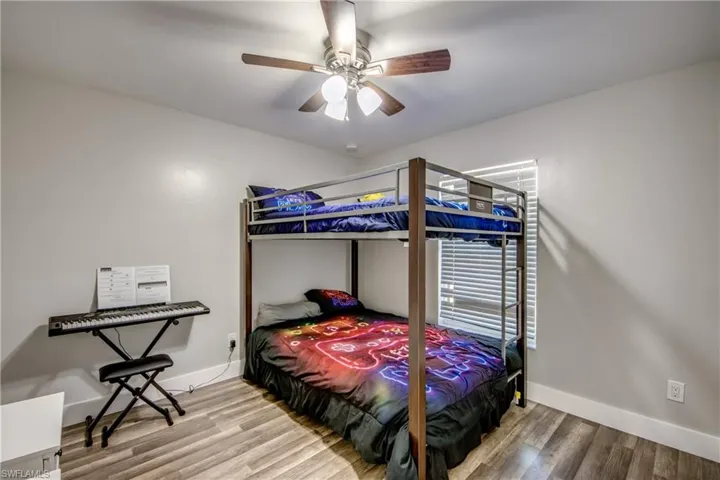 Bedroom with light wood-style floors and ceiling fan