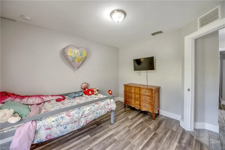 Bedroom featuring light wood finished floors and baseboards