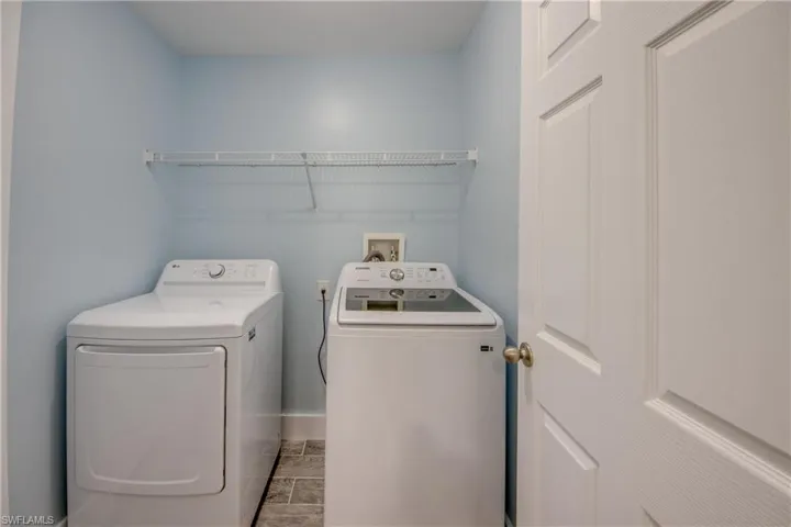 Laundry area featuring washer and clothes dryer and baseboards
