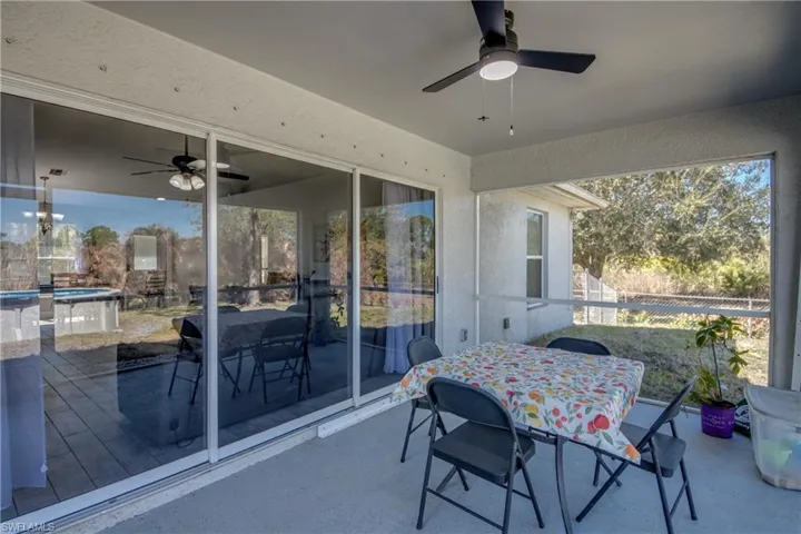 View of patio with a ceiling fan and outdoor dining space