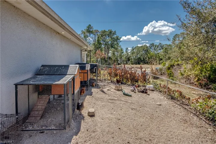 Fenced backyard featuring exterior structure and an outdoor structure