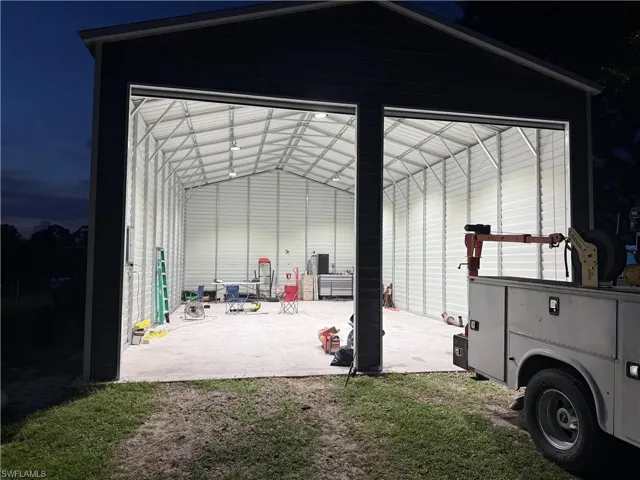 View of outbuilding featuring a sunroom and a garage