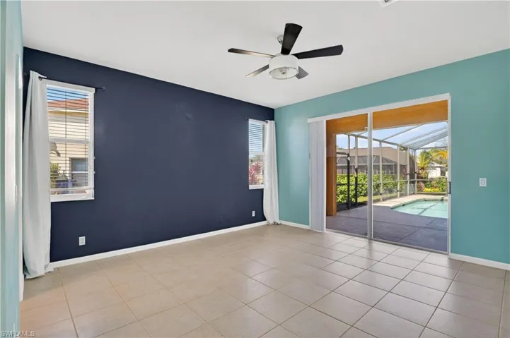 Master bedroom with a sunroom, a ceiling fan, plenty of natural light, and tile patterned floors