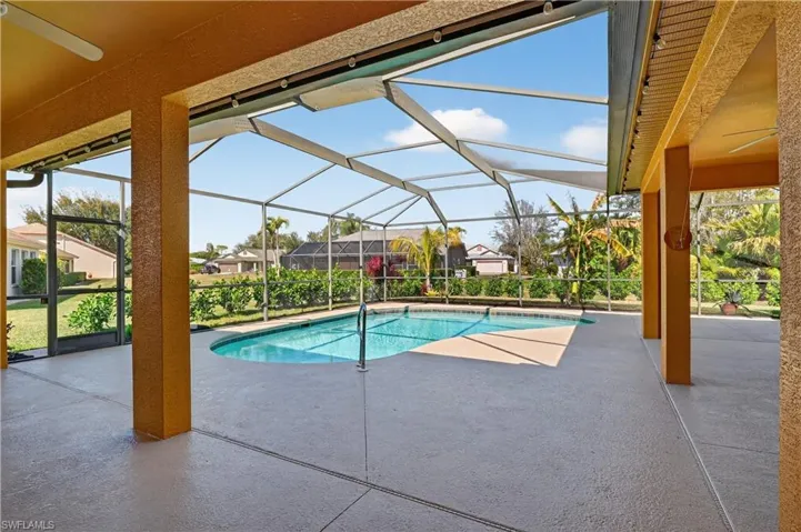 Swimming pool featuring a patio, a lanai, and a sunroom