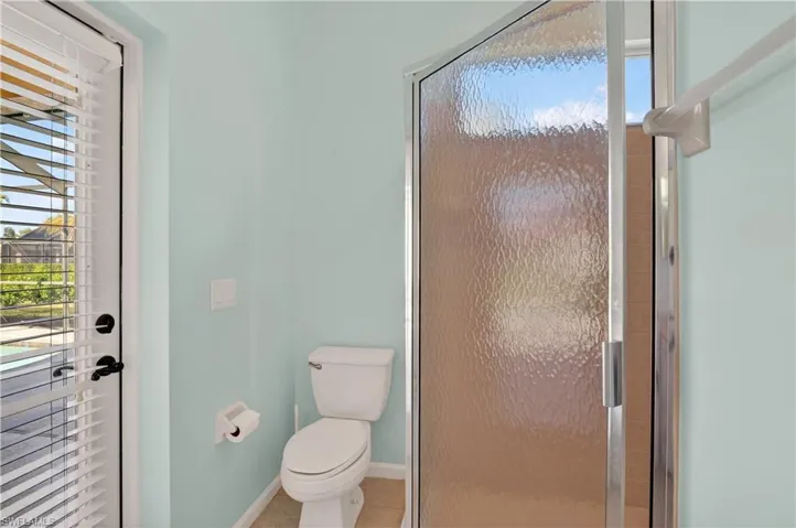 Full bathroom with a shower stall and tile patterned floors
