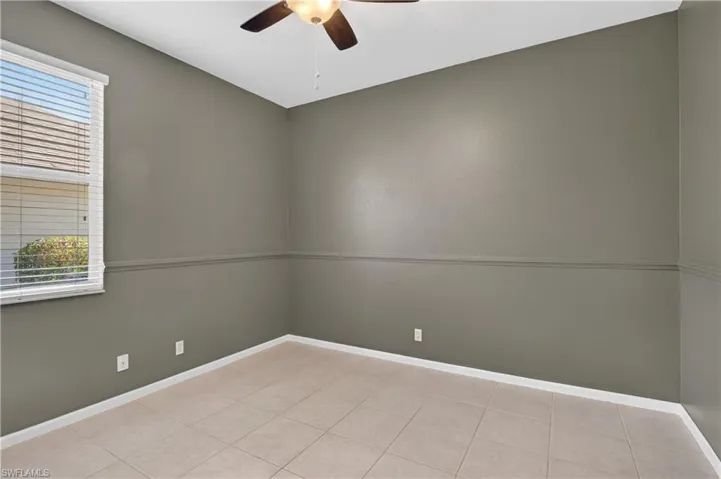Bedroom #2with ceiling fan, healthy amount of natural light, and light tile patterned flooring