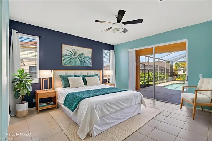 Bedroom with a sunroom, multiple windows, access to exterior, and a ceiling fan